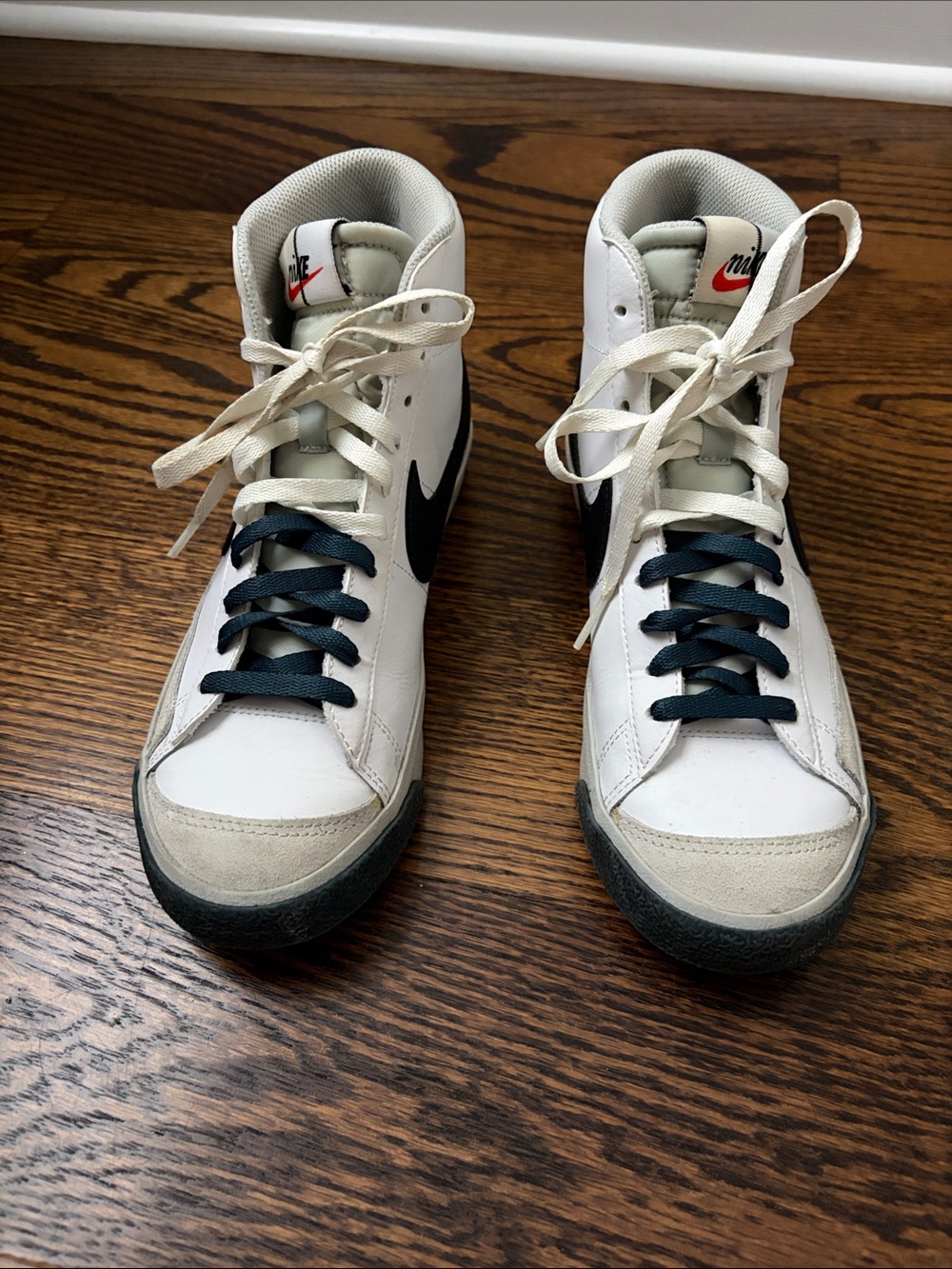 Nike White High-Top Sneakers with Black Swoosh and Navy Laces
